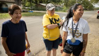 Uvalde mayoral candidate Kimberly Mata-Rubio, right, speaks with Uvalde resident Antonia Rios, left, alongside campaign manager Dr. Laura Barberena, Saturday, Oct. 21, 2023, in Uvalde, Texas. (AP Photo/Darren Abate)