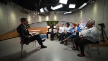 NBC 5 senior investigative reporter Scott Friedman, left, talks with five families whose loved ones were victims of violence, November 2024.