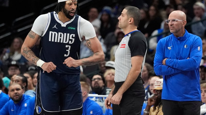 Dallas Mavericks forward Anthony Davis (3) questions a call by referee Mousa Dagher, center, as head coach Jason Kidd looks on during the second half of an NBA basketball game against the Atlanta Hawks in Dallas, Wednesday, April 2, 2025. (AP Photo/LM Otero)