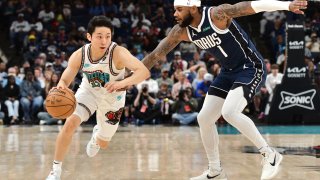 Memphis Grizzlies guard Yuki Kawamura (17) handles the ball against Dallas Mavericks guard Jaden Hardy (1) in the first half of an NBA basketball game Sunday, April 13, 2025, in Memphis, Tenn. (AP Photo/Brandon Dill)
